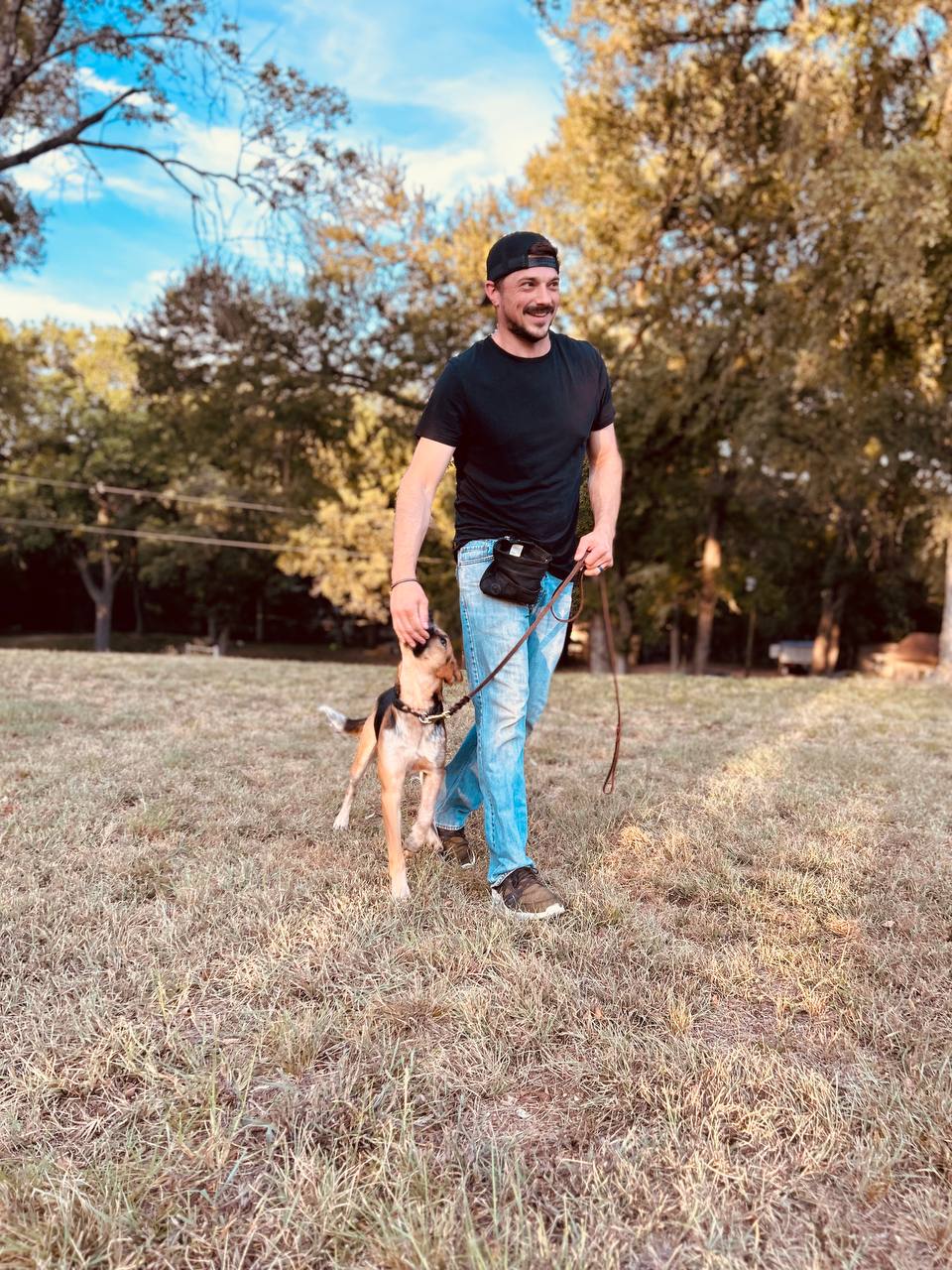 A Pro 36 trainer walking a dog in training
